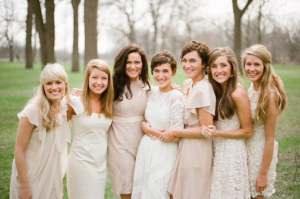 Soft natural light falls on vintage-adorned bride and bridesmaids.