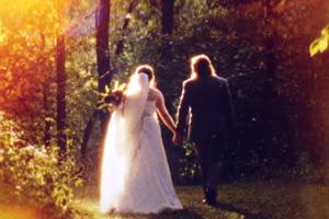 Bride and groom walking in woods on vintage Super 8 film