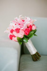 tropical pink bouquet propped on pale blue couch
