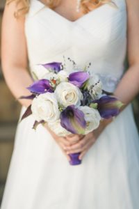 Bride's handmade bouquet with purple calla lilies and white roses